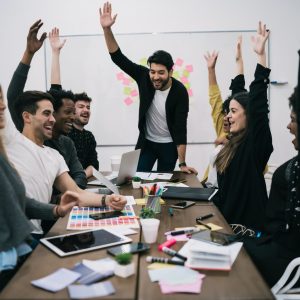 business-team-celebrating-with-raised-up-hands-.jpg