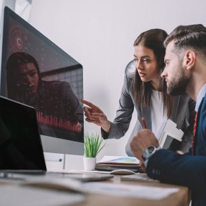 selective-focus-of-information-security-analysts-using-charts-on-computer-monitors-while-working-in.jpg